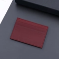 Slim burgundy leather card holder with lychee pattern and three precise card slots - Burgundy