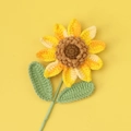 Macro detail of handmade crochet sunflower showing intricate petal texture and yellow yarn - Gradient Yellow