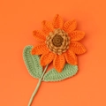 Detailed view of handmade crochet sunflower petals and textured brown yarn flower center - Orange