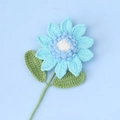 Close-up of handmade crochet blue sunflower with detailed knitted petals and green stem - Blue