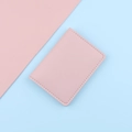Slim pink leather card holder with white stitching on a pastel duotone background - Pink