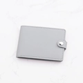 Slim grey faux leather card holder for women with silver snap button and textured finish - Gray