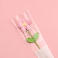 Handmade crochet pink flower bouquet with green leaves in LOVE printed clear packaging - Pink