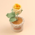 Detail of hand-crocheted yellow rose with green leaves and a leather handmade label - Gradient Yellow