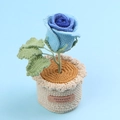 Detail of blue crochet rose in a knitted pot with a Handmade Limited Edition leather label - Gradient Blue