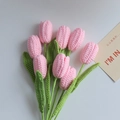 Handmade knitted pink tulip bouquet with seven flowers and green leaves on grey background - Closed Tulip Single Finished Product / Pink