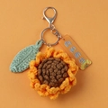 Handmade crochet sunflower keychain with green leaf and orange tag on orange background - Sunflower (Lobster Claw)