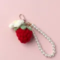 Detail of handmade crochet strawberry keychain with white flower and pearl bead strap - Red Strawberry + Puff Flower + Pearl Chain / Red