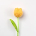 Handmade crochet tulip in bright yellow yarn with green stem and leaf on white background - Ginger Yellow - Finished Single Stem