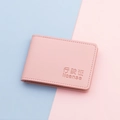 Pink PU leather vehicle license holder with debossed text on a pastel background - True Powder