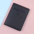 Minimalist black leather RFID passport holder with airplane logo on pastel background - Black