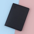 Classic black leather passport holder with airplane embossment on colorful background - Black