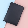 Universal black faux leather passport holder with a minimalist professional textured finish - Black