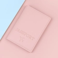 Pink PU leather passport holder featuring embossed airplane icon and passport text - True Powder