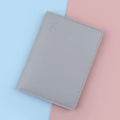 Grey leather passport holder with embossed airplane icon on soft dual-tone background - Gray