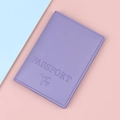 Lavender passport cover with aircraft logo and passport text on a pastel background - Purple