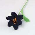 Close-up of handmade crochet black lily flower with yellow stamen and green stem details - Open Tulip Bouquet / Black