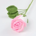 Macro shot of handmade crochet rose with pink gradients and detailed green leaves - White with Bright Pink Edge