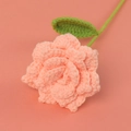 Detailed macro view of a handmade crochet rose in peach pink with delicate knit petals - Skin Pink