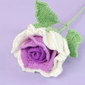 Detail of handmade crochet rose with purple core, white petals and green leaves - Gradient Purple