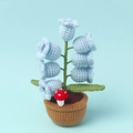 Detailed close-up of handmade crochet lily of the valley lamp with light blue flowers - Blue