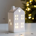 White ceramic light-up house with heart detail and warm glow for Christmas decor - Style E Heart Hollow House