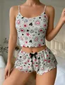 Detail of heart print camisole and ruffle shorts with black silk bow decoration - White Red Black Heart Star Print
