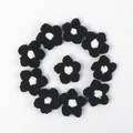 Detailed macro view of 11 handcrafted black and white crochet puff flowers for DIY crafts - Puff Flower - Black Petals