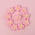 Macro shot of 11 handmade pink crochet macaron flowers for DIY hair accessories - Puff Flower - Pink Petals