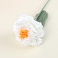 Detailed macro shot of a white and orange handmade crochet peony flower and leaf - White