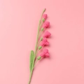 Detailed view of a handmade crochet pink freesia flower with green stem and leaf - Meng Si Freesia (6 Flowers) / Rose Red