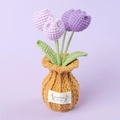 Close-up of handmade knitted purple tulip flowers in a yellow woven pot with a label - Gradient Purple-Tulip Brown Vase