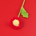 Handmade crochet daisy flower in red and yellow with green stem on red background - Red Daisy Bouquet