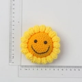 Handmade crochet sunflower charm with smiley face, 7cm yellow knitted flower accessory - Reverse Crochet Smiley Face Sunflower Head