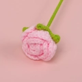Detailed view of handmade crochet pink rose with green leaves and knitted yarn texture - Pink