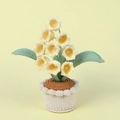Detail of handmade crochet lily of the valley with yellow petals and pearl stamen - Yellow