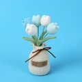 Detail of handmade crochet tulip bouquet with white woven vase and Hand Made label - Gradient Blue Tulip (Vase Base)