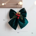 Dark green velvet Christmas bow with red berries, pine needles, and golden bells - M Green