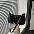 Glossy black baguette shoulder bag with elegant gold bow hardware detail - Black