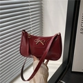 Glossy red patent leather underarm bag with a golden bow metal buckle on front - Red