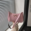Pink glossy patent leather underarm bag with a golden bow charm and shoulder strap - Pink