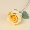 Close-up detail of a handmade crochet yellow rose with realistic knitted texture and stem - Thai Rose Stem / Gradient Yellow