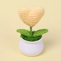 Close-up of handmade crochet yellow heart potted plant with green leaves and white pot - Yellow Heart Potted Plant
