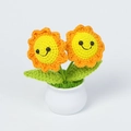 Close-up of handmade crochet sunflower plant with smiling faces in a white ceramic pot - Yellow Double Head