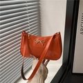 Bright orange patent leather underarm bag with a golden bow and sleek glossy finish - Orange