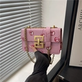 Pink crossbody bag with cherry prints, gold chain strap, and litchi grain texture - Pink