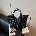 Glossy black pleated cloud bag with round handles and a detachable shoulder strap - Black