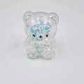 Detail of bear squishy toy with blue star glitter filling and glossy resin texture - Jade Blue Pearl