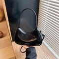 Glossy black crescent bag with retro wrinkled texture and fashion-forward moon shape - Black