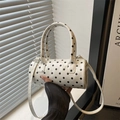 Chic black and white polka dot mini cylindrical Boston bag with top handles and shoulder strap - White
